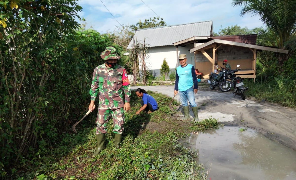 “Babinsa Koramil 1014-01/Arsel Serda Sutrisno Bersama Warga Binaanya Gotong-royong Bersihkan Parit “.
